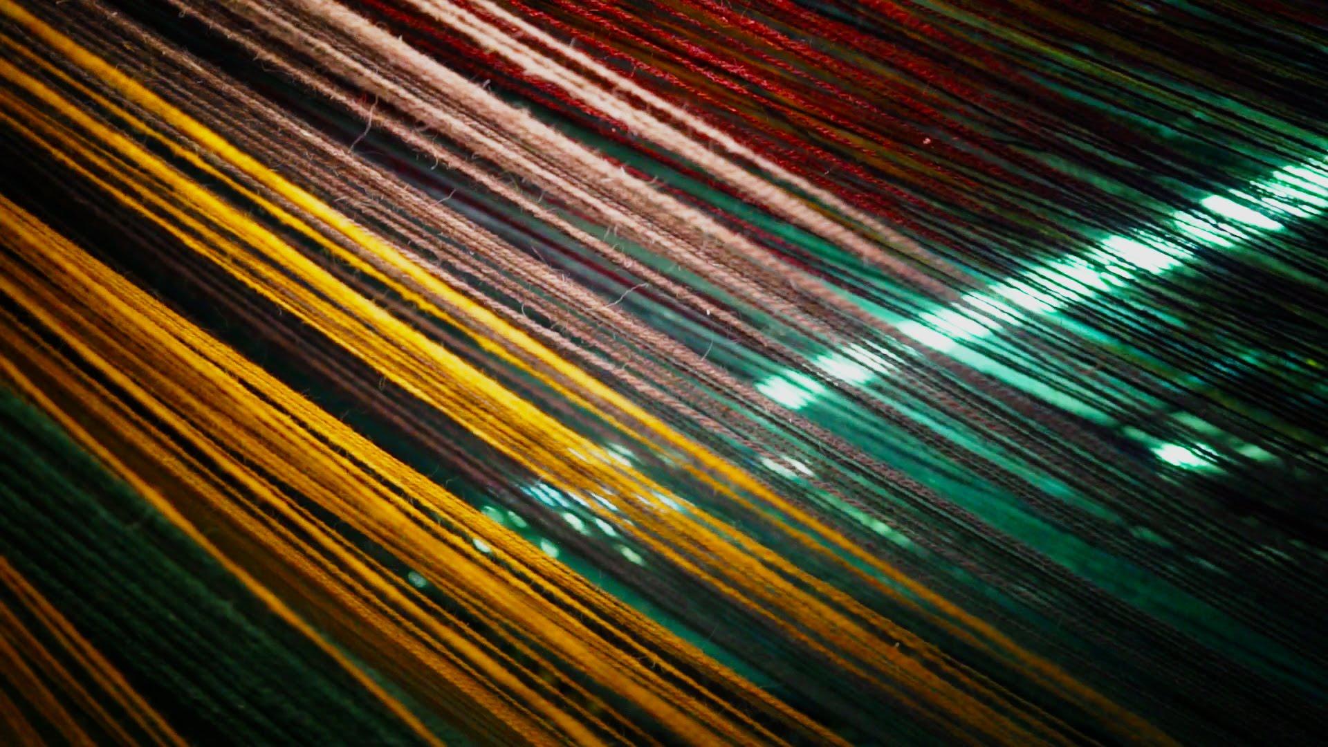 Vibrant strands of wool in various colors showcase the beauty of British wool at Yorkshire Sculpture Park.
