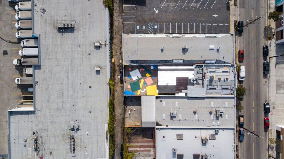 Aerial view of Hem's vibrant first US showroom in downtown Los Angeles with colorful confetti installation and surrounding rooftops.