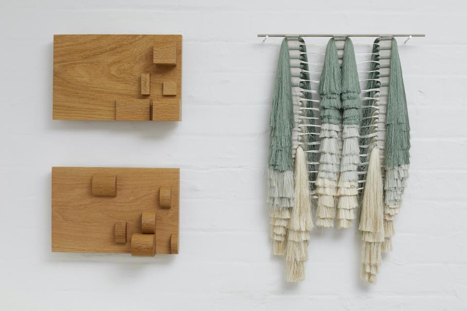 Contemporary wall artworks featuring wooden reliefs and textured textile installations showcased at House on Mars gallery.