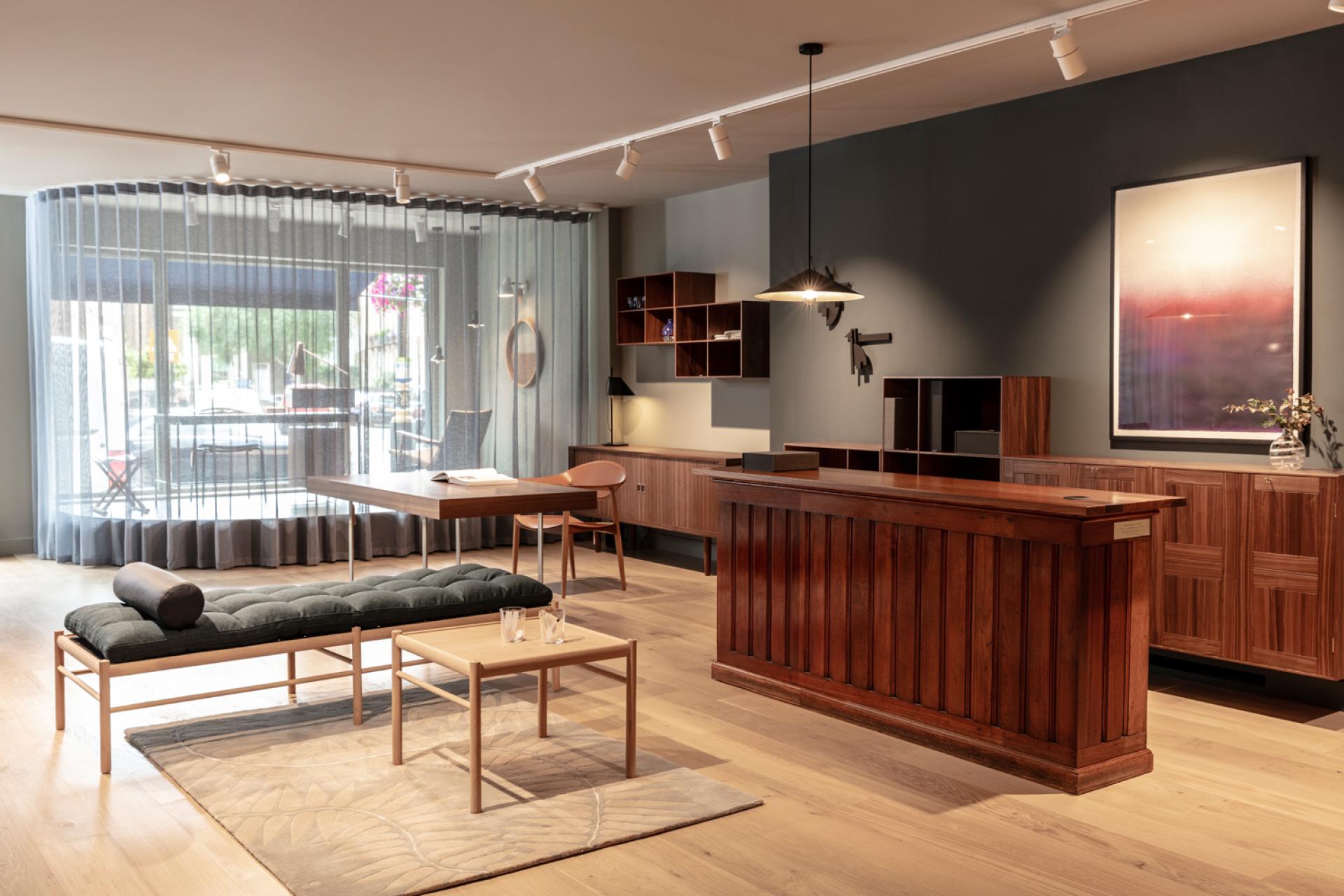 Stylish interior of Carl Hansen & Son's London flagship store featuring wooden furniture and modern Scandinavian design elements.