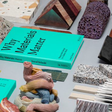 Colorful natural and man-made materials arranged around the book "Why Materials Matter," highlighting sustainability and design innovation.