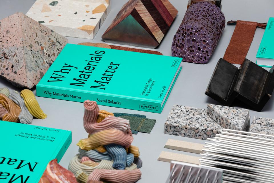 Colorful natural and man-made materials arranged around the book 
