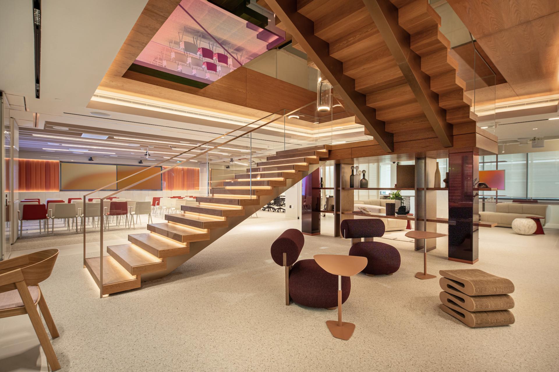 Modern office interior in Dubai featuring vibrant colors, natural wood accents, and creative seating areas, promoting a joyful workspace.