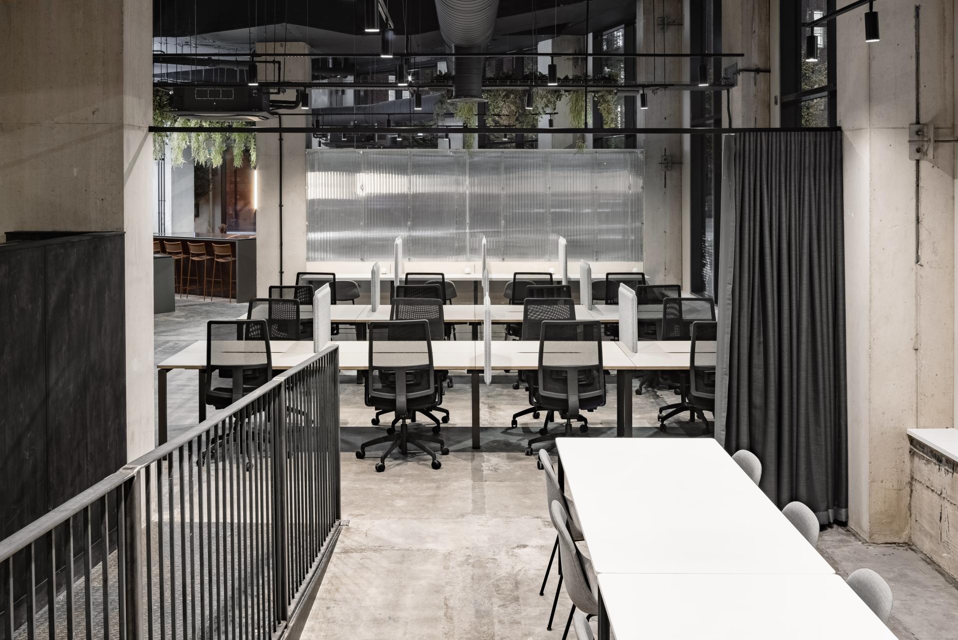 Modern co-working space in Manchester featuring minimalist design, flexible workstations, and an open layout for creativity.