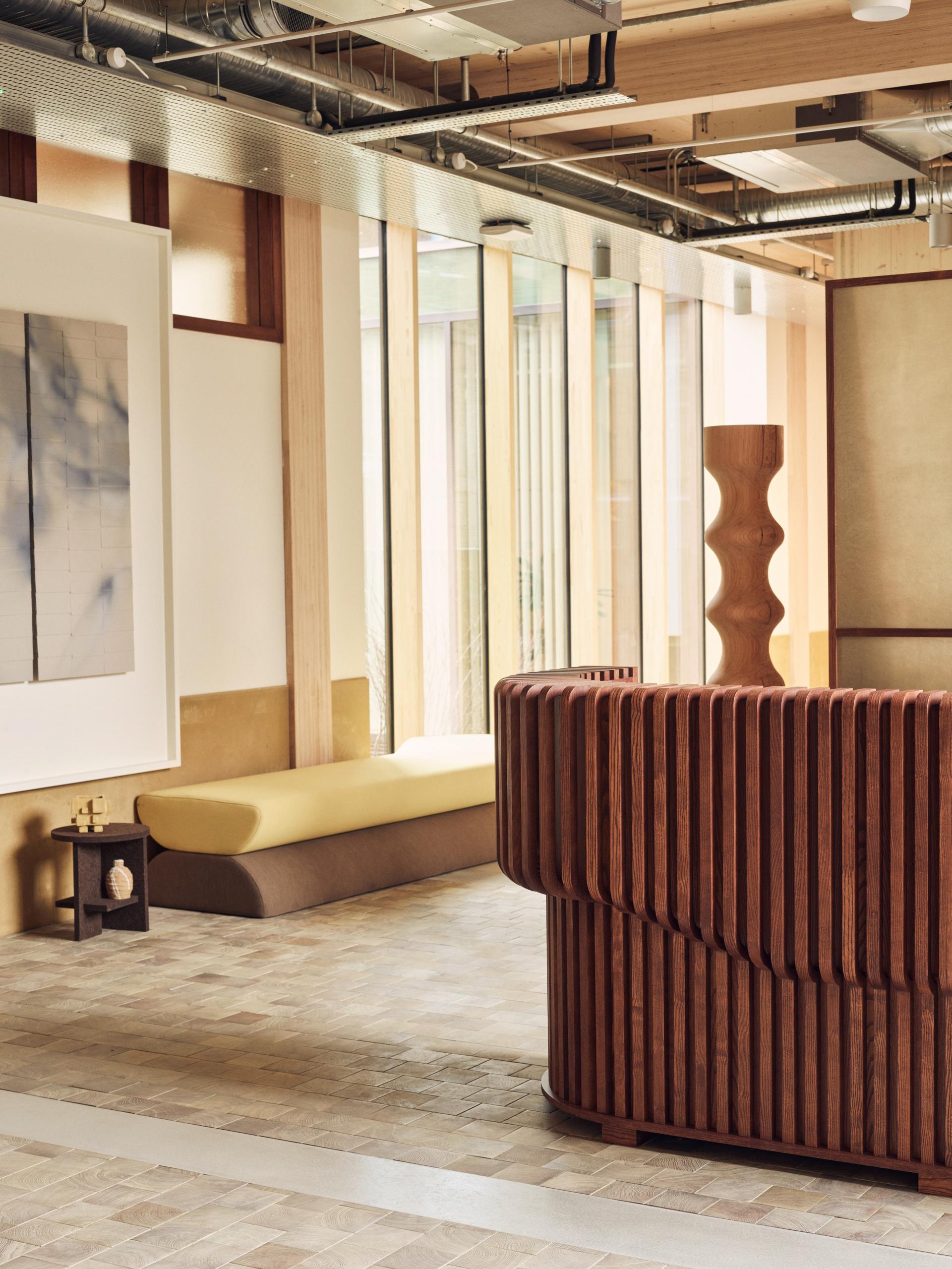 Interior view of the Black & White Building featuring wooden furniture and sustainable design elements.