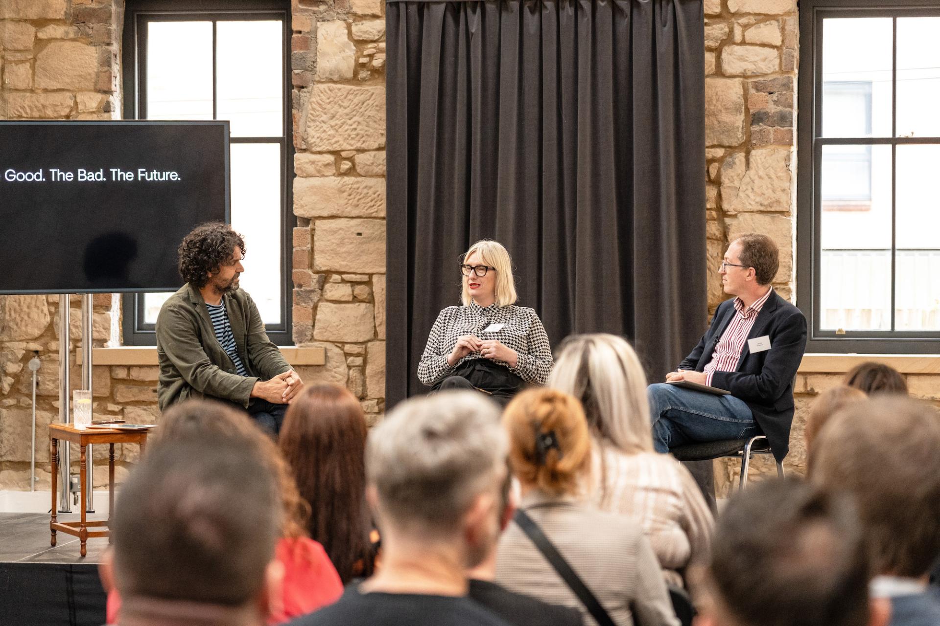 Panel discussion at the Glasgow Property Outlook seminar featuring speakers discussing future trends in real estate.