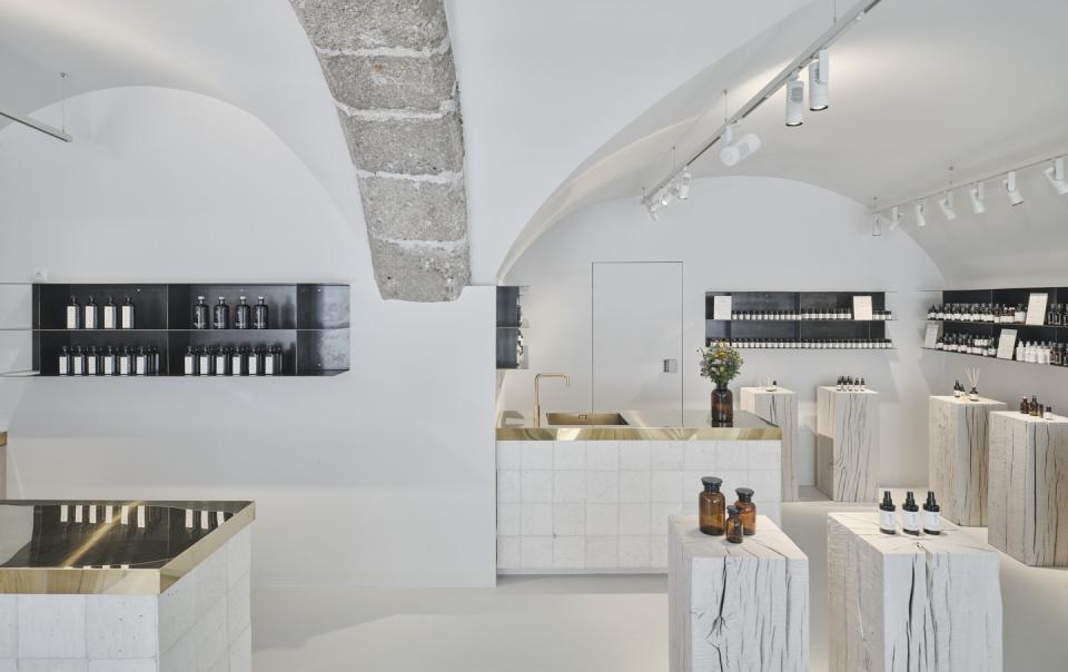 Minimalist interior of Saint Charles store featuring natural cosmetics, wooden displays, and earthy decor in Salzburg.
