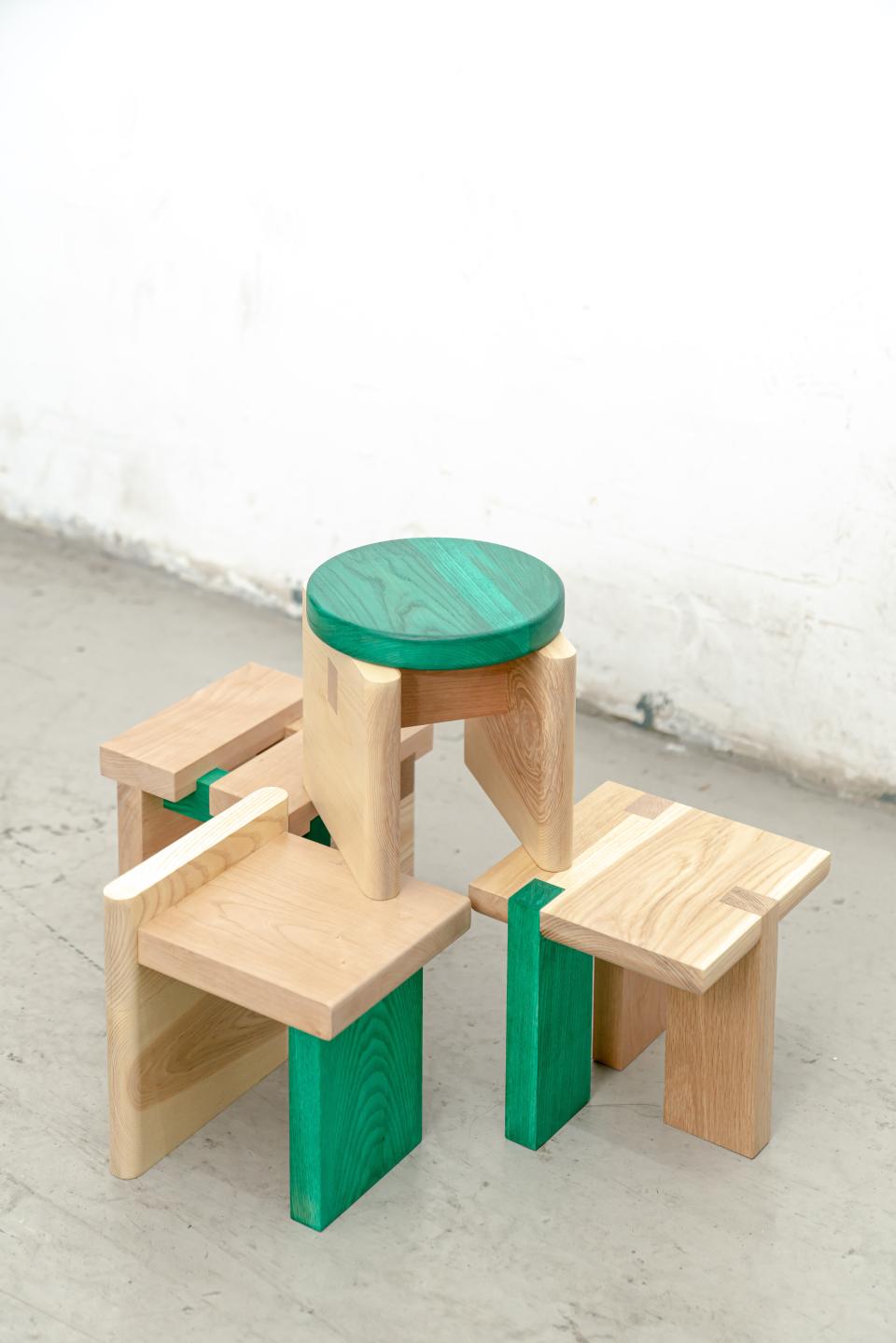 Mini-Stools by Napp Studio feature wooden designs with green accents, showcasing versatile, adaptable furniture craftsmanship.