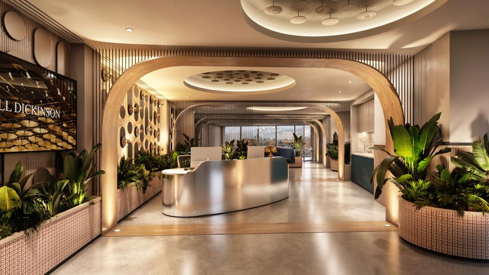 Modern reception area of Hill Dickinson's new Manchester workspace, featuring elegant design and lush greenery.