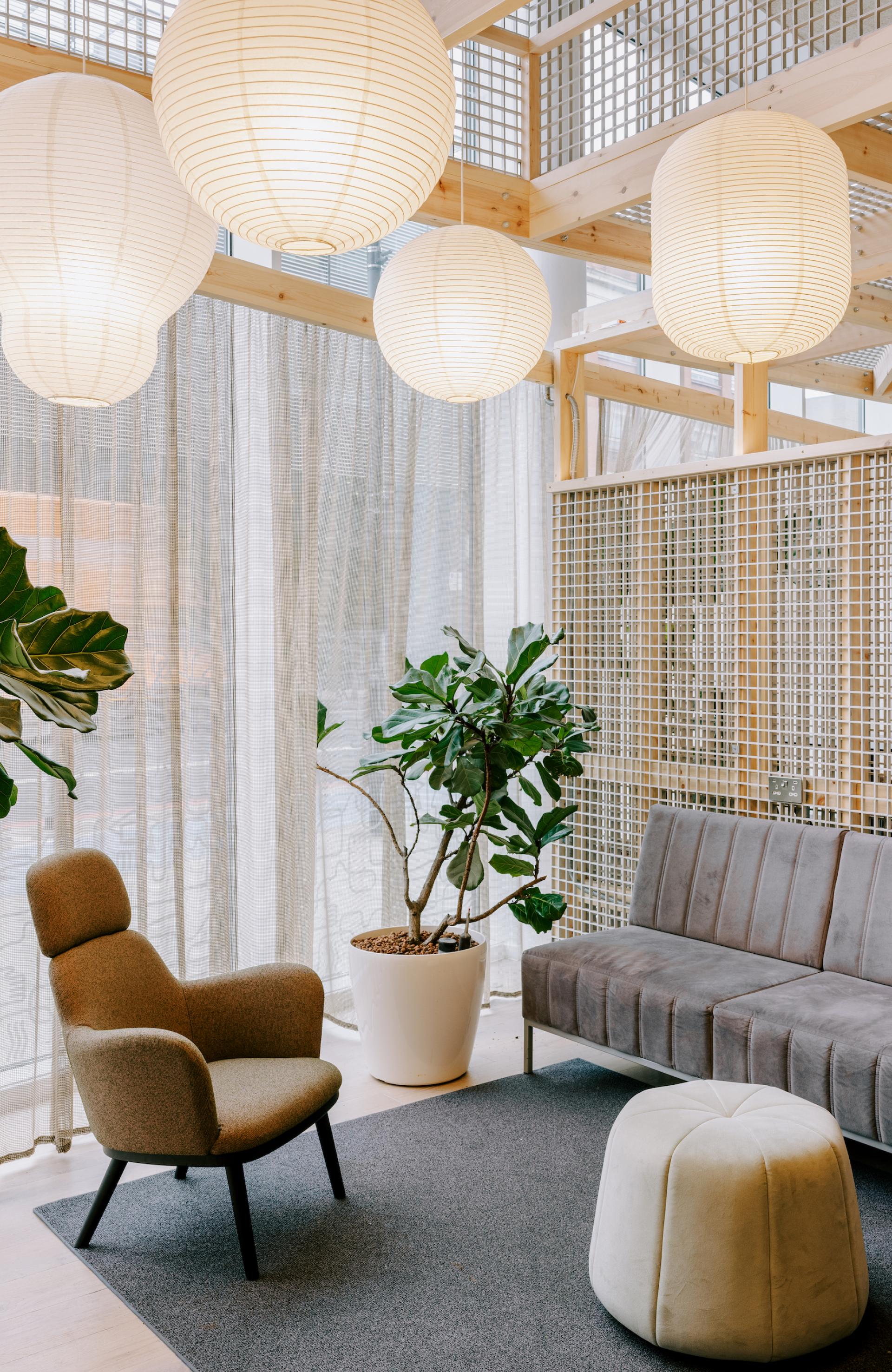 Stylish lounge area featuring modern furniture, plants, and ambient lighting, inspired by Mile End's historic charm.