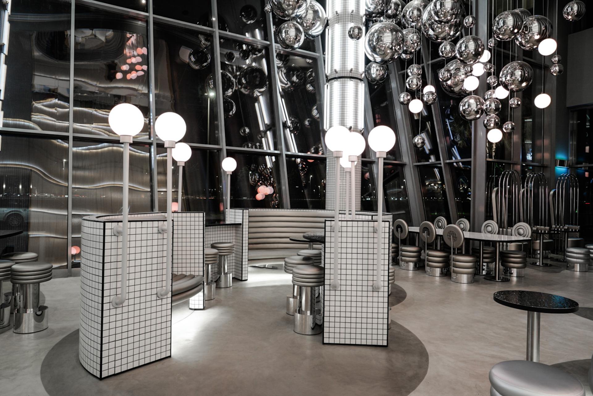 Contemporary interior design of MO bakehouse and espresso bar featuring geometric furniture and modern lighting in Khobar.