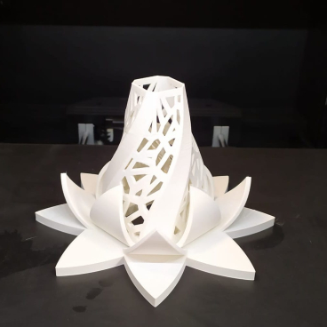 3D printed sculpture made from post-consumer plastic, showcasing intricate geometric patterns and a floral design.