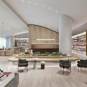 Modern book shop interior featuring elegant design, bookshelves, reading areas, and a landscaped central seating arrangement.
