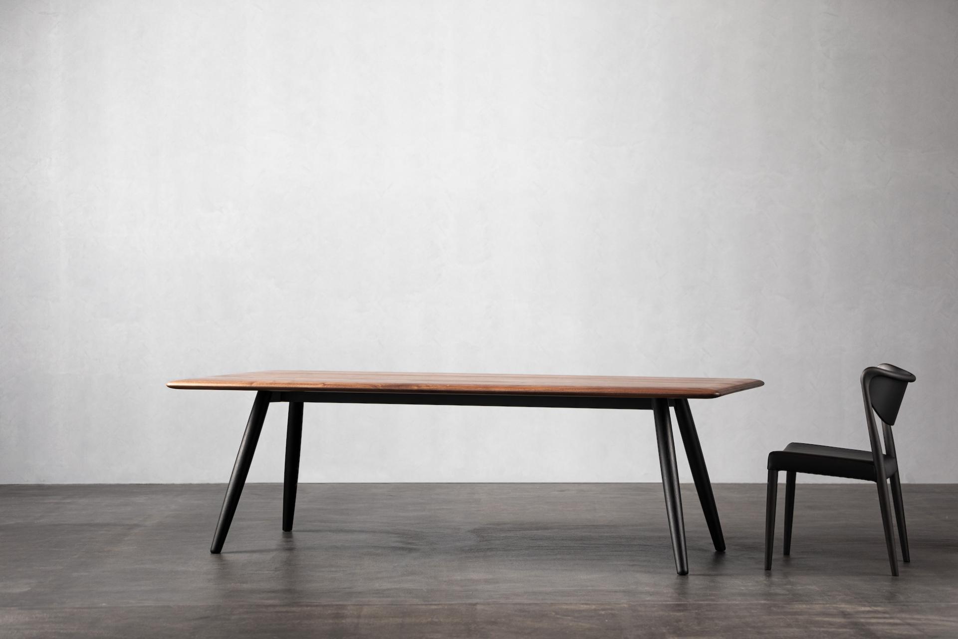 Minimalist dining table and chair by Ritzwell, showcasing Japanese design elements against a simple backdrop.