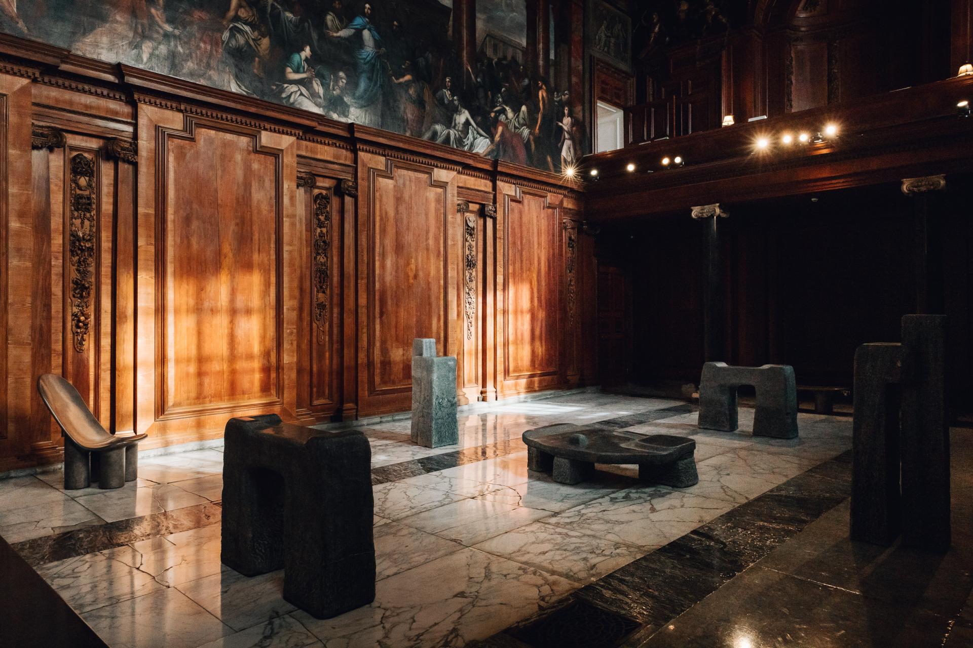 Contemporary stone sculptures in a historic room at Chatsworth House, highlighting its rich artistic heritage and materiality.