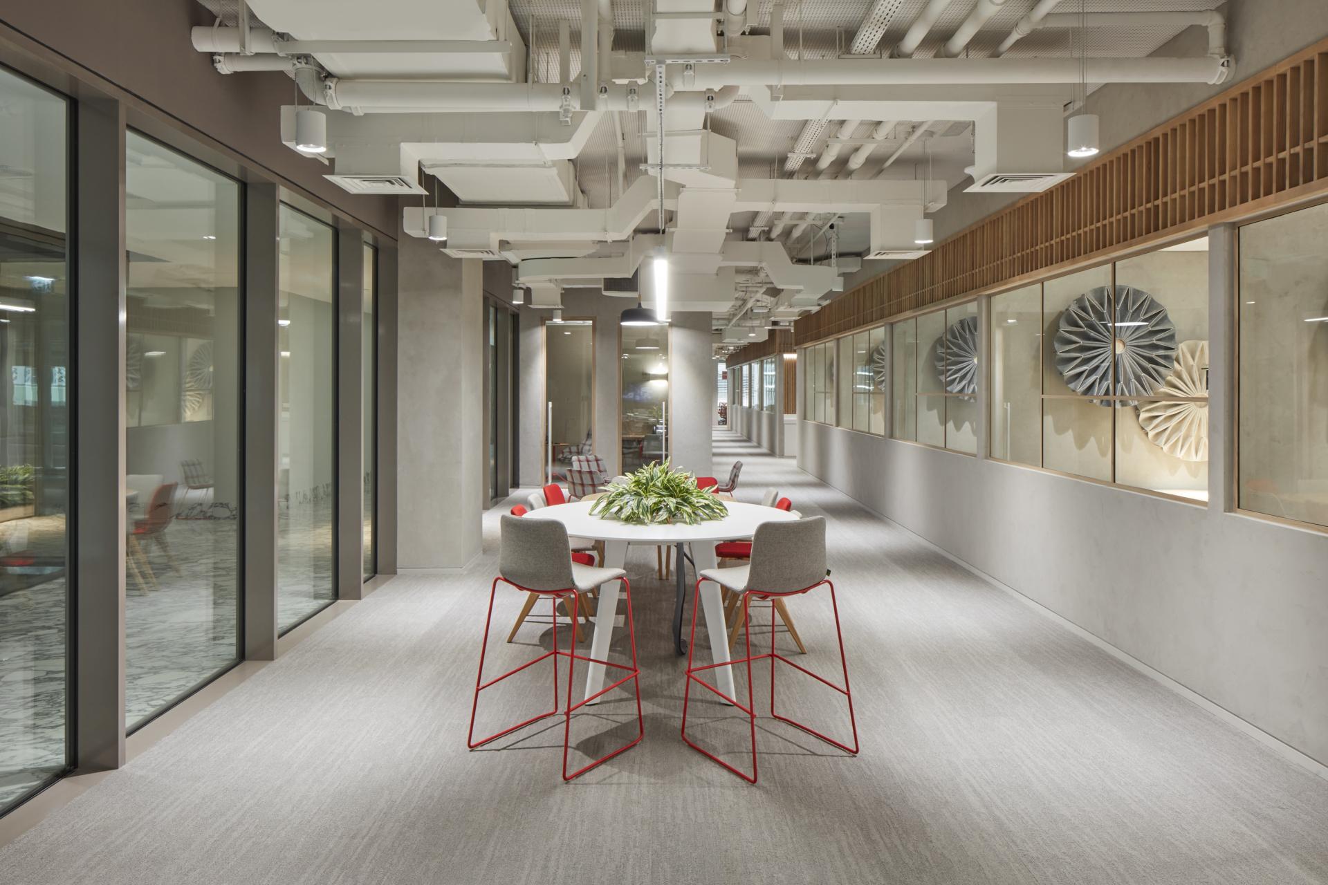 Modern office interior of Takeda's Dubai HQ showcasing Japanese and Emirati design elements with collaborative seating and decorative features.