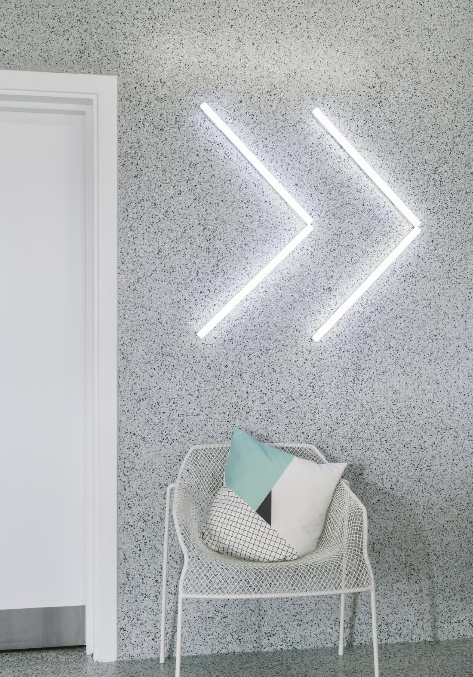 Stylish corner of the Material Source Studio in Glasgow featuring decorative lighting and modern seating with a patterned cushion.