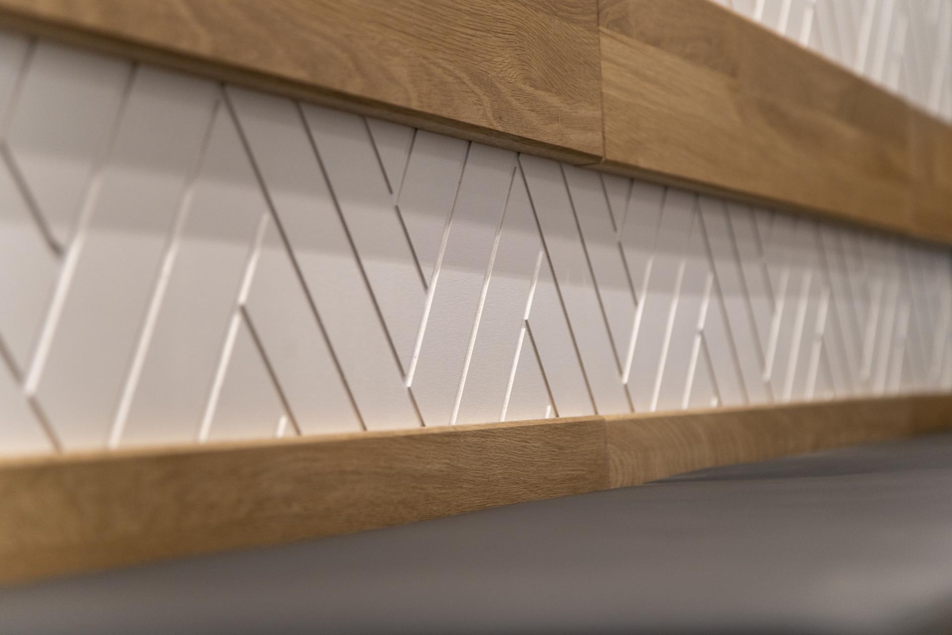 Textured white wall paneling with wooden accents, showcasing minimalistic design in the interior of Bread Lab Bakery, London.