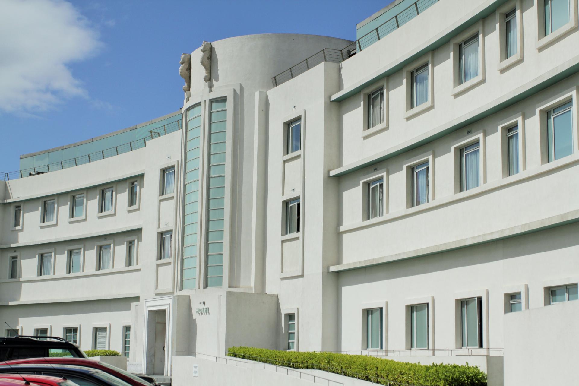 Art Deco building exterior with lush greenery, showcasing the architectural charm of northern seaside towns.