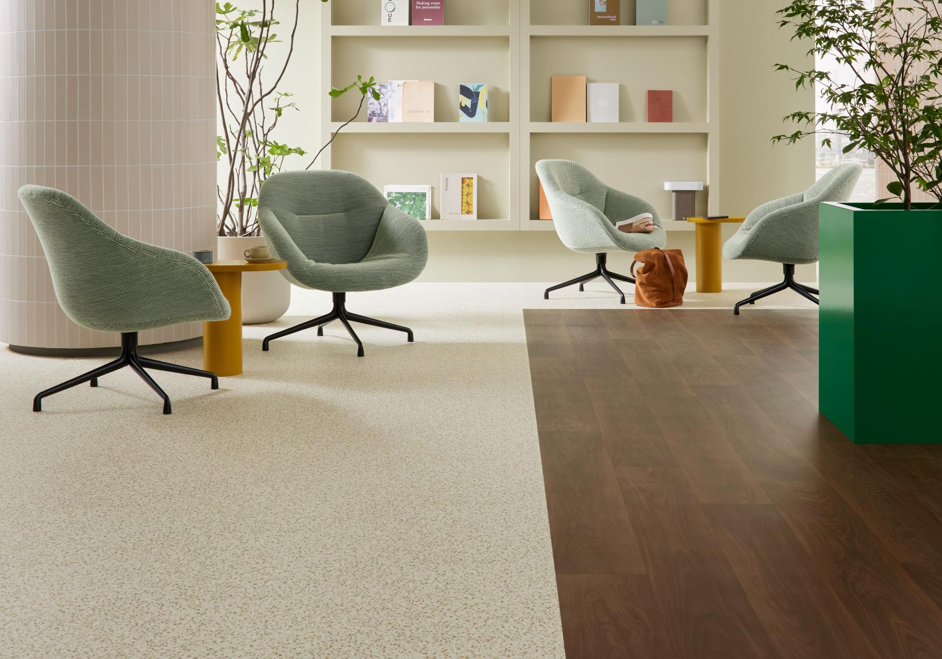 Modern interior featuring Forbo's Modul’up flooring, stylish seating, and a nature-inspired color palette.