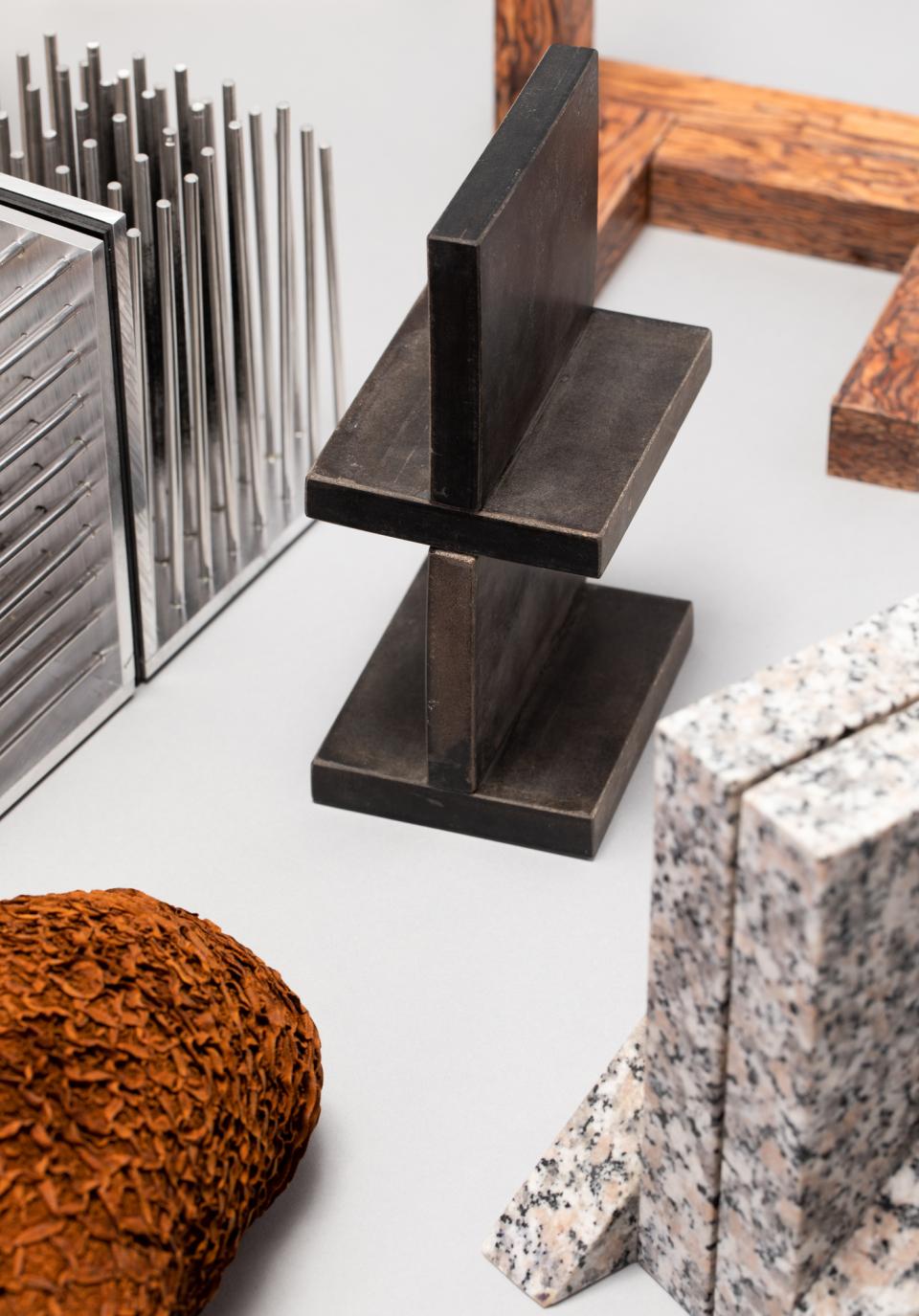 A collection of diverse natural and man-made materials, showcasing textures and forms relevant to sustainable design.