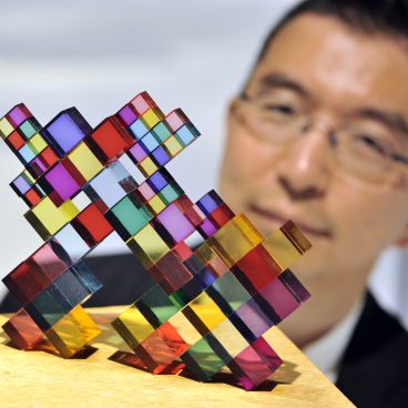 Colorful architectural model by Sou Fujimoto on a wooden base, showcased during his exhibit at Japan House London.