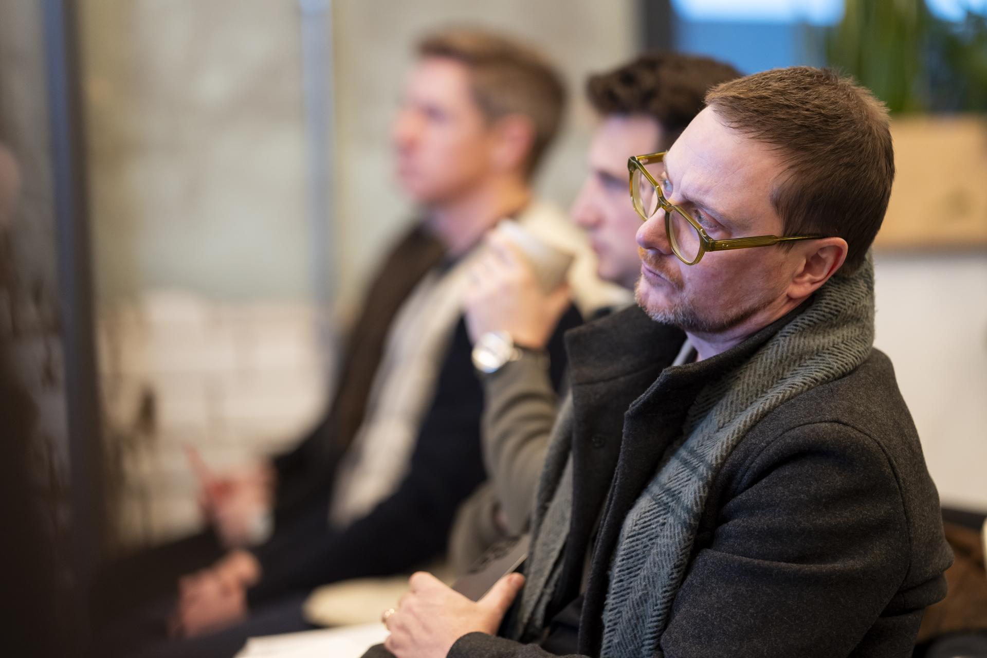 Attendees listening intently during a discussion about graphene applications at the Graphene Engineering Innovation Centre in Manchester.