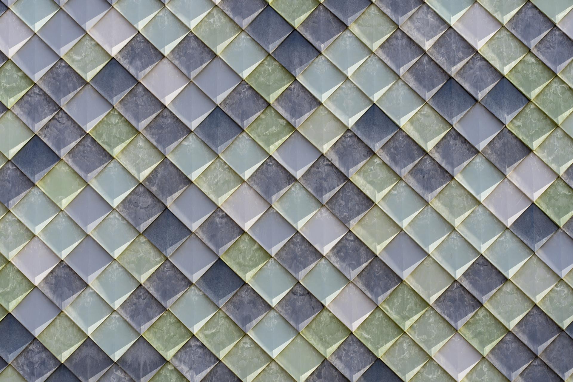 Colorful mosaic tiles in a diamond pattern showcase innovative design in sustainable construction by Pretty Plastic.