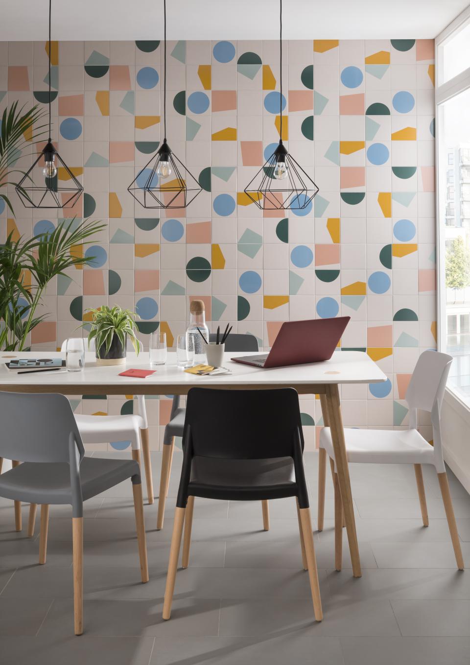 Contemporary dining area featuring Tom Pigeon's exclusive tile collection, surrounded by stylish chairs and modern lighting.