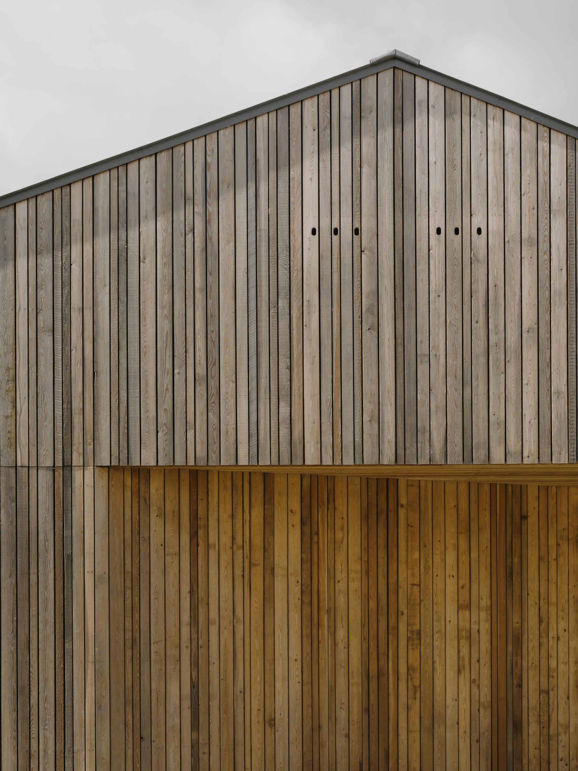 Sustainable wooden facade of the FarmED centre in the Cotswolds, showcasing regenerative architecture and modern design.