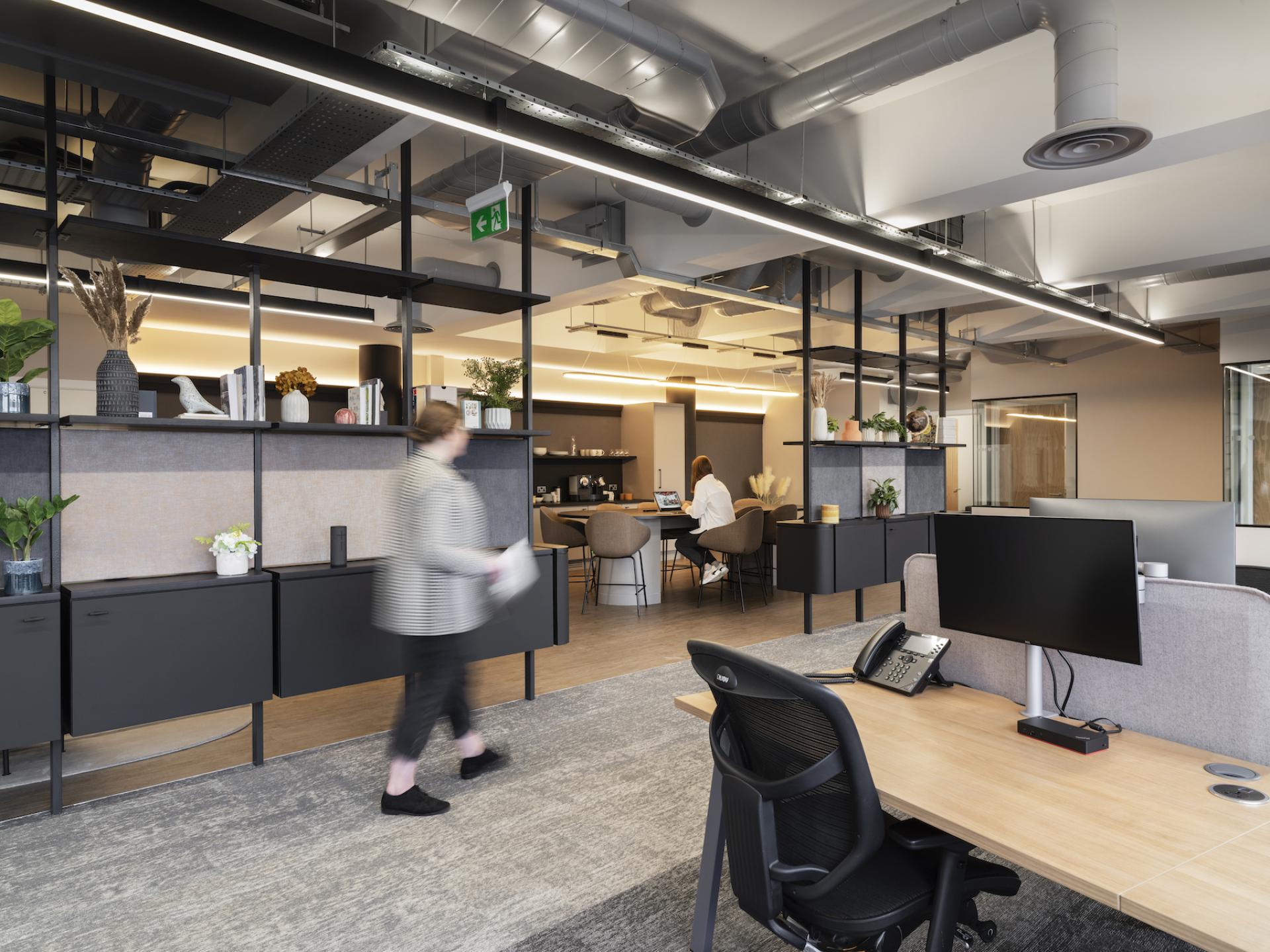 Modern office interior featuring sleek design elements, collaborative workspaces, and vibrant decor for Tosca Debt Capital in Manchester.