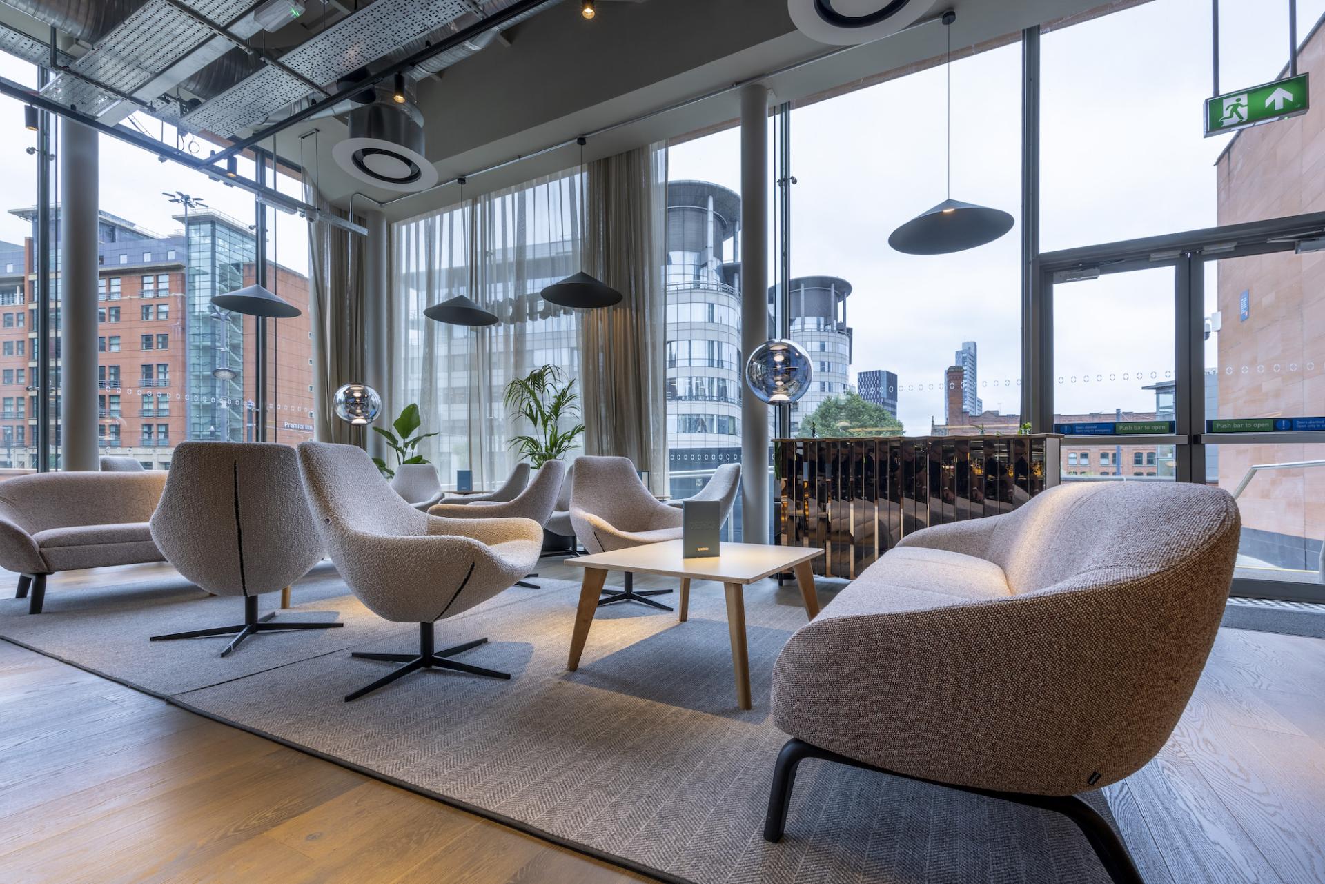 Modern lounge seating area featuring stylish chairs and natural light, located in Material Source Studio, Manchester.