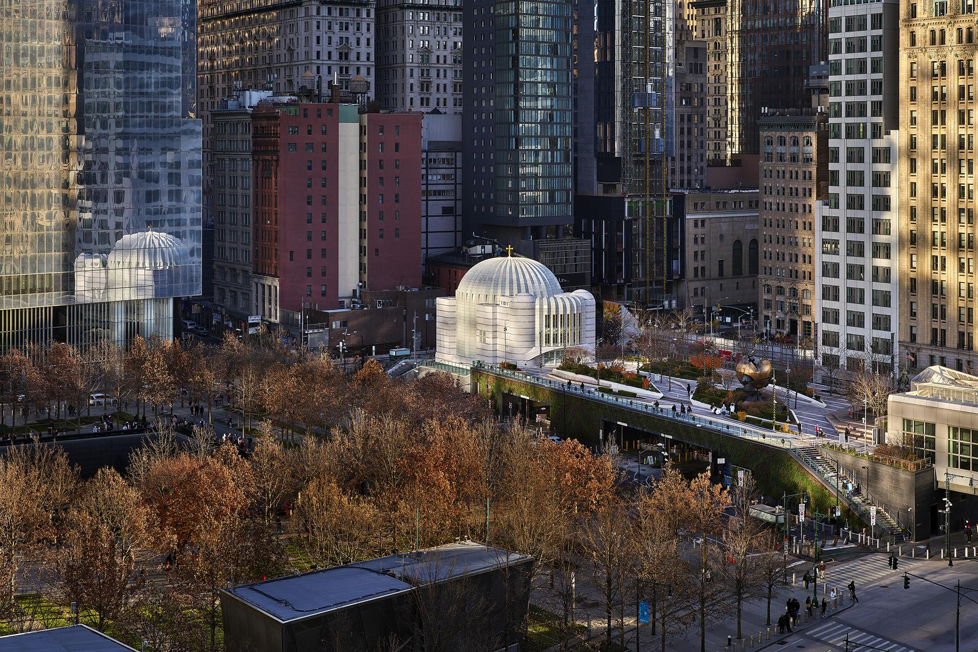 Urban landscape showcasing Santiago Calatrava's architectural design, featuring a modern dome and surrounding greenery in a bustling city.