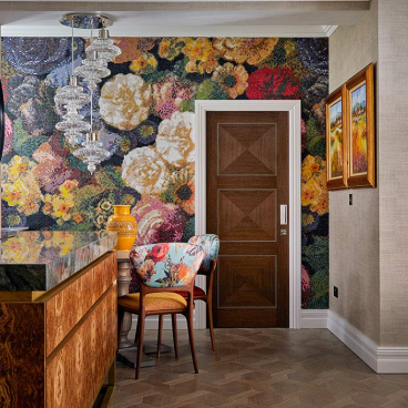Luxurious Knightsbridge apartment entry featuring floral mosaic wallpaper, stylish chandelier, and decorative furnishings inspired by Van Gogh.