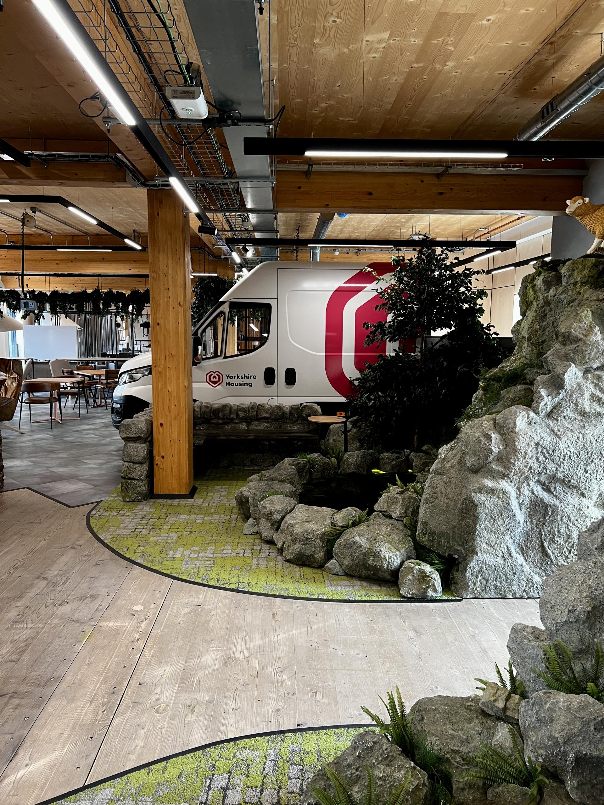 Yorkshire Housing van in Leeds' first net zero carbon workspace, featuring a natural-themed interior with greenery and seating areas.