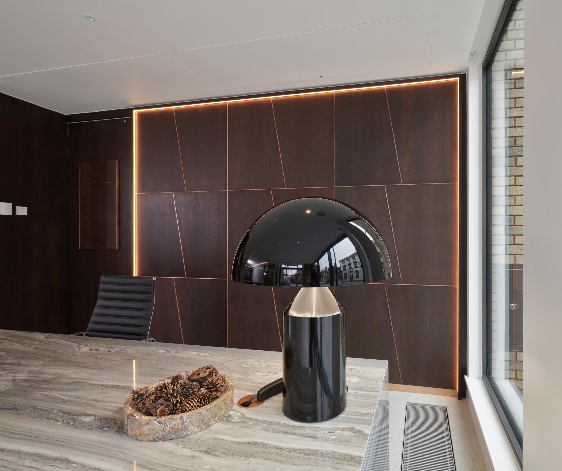 Elegant interior design featuring a modern lamp, marble table, and nature-inspired elements at One Victoria Street, Windsor.