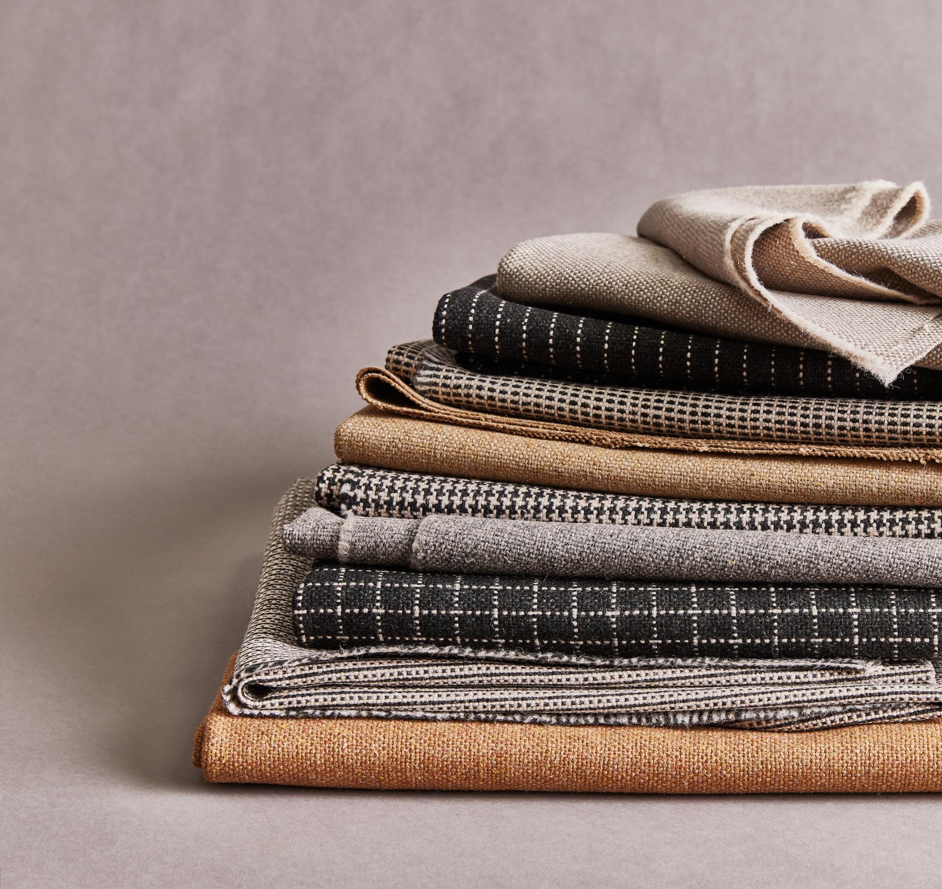 Sustainable textiles showcasing Camira's monochrome mini patterns in earthy tones and unique textures, perfect for eco-friendly designs.