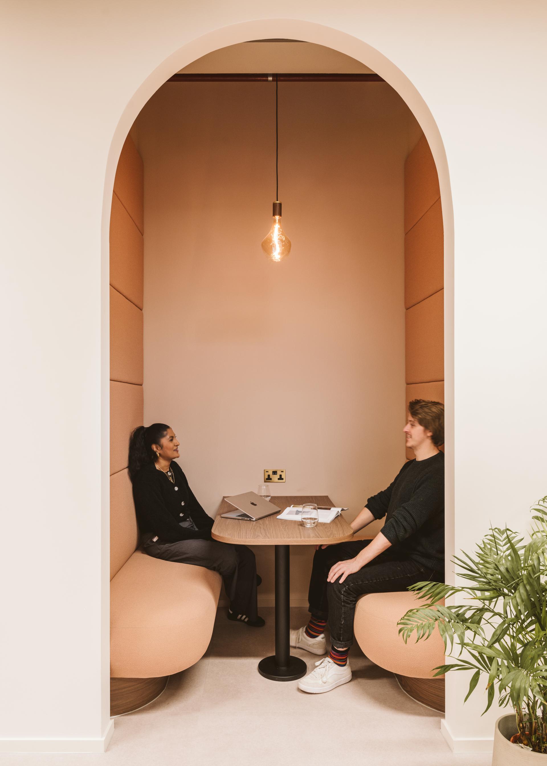 Collaborative workspace featuring two individuals engaged in discussion, designed to enhance productivity at Butternut Box.