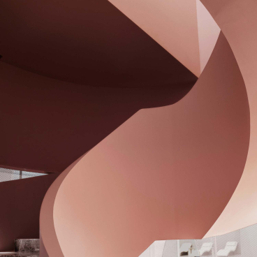 Curved interior architecture of the Rhythm community centre, showcasing innovative design and modern aesthetics in a floating urban environment.