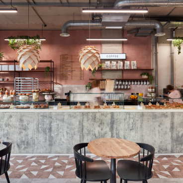 Modern coffee counter at Yeast Bakery, featuring artisan pastries and a stylish urban design by Run For The Hills.