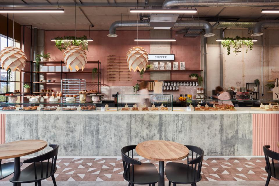 Modern coffee counter at Yeast Bakery, featuring artisan pastries and a stylish urban design by Run For The Hills.