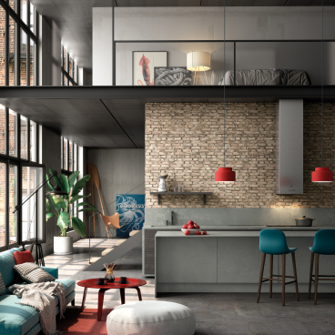 Modern industrial kitchen and living area featuring sustainable design elements, vibrant decor, and natural light throughout.