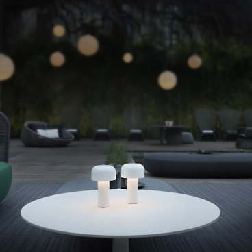 Portable outdoor lighting on a coffee table in a stylish garden seating area, enhancing the ambiance for outdoor living.