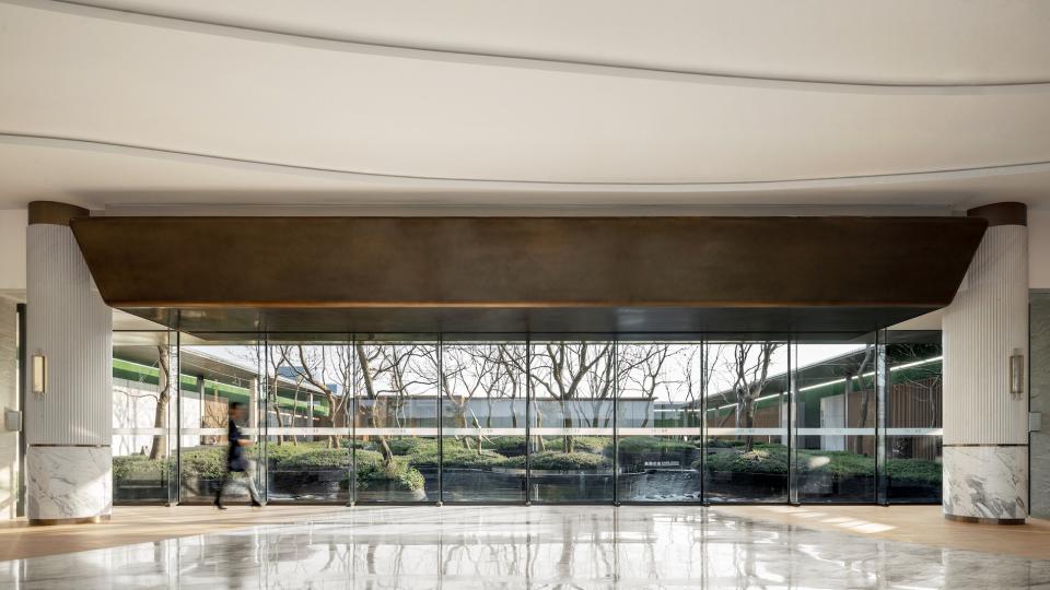 Modern coffee space designed by Karv One, featuring elegant architecture and a serene outdoor view.