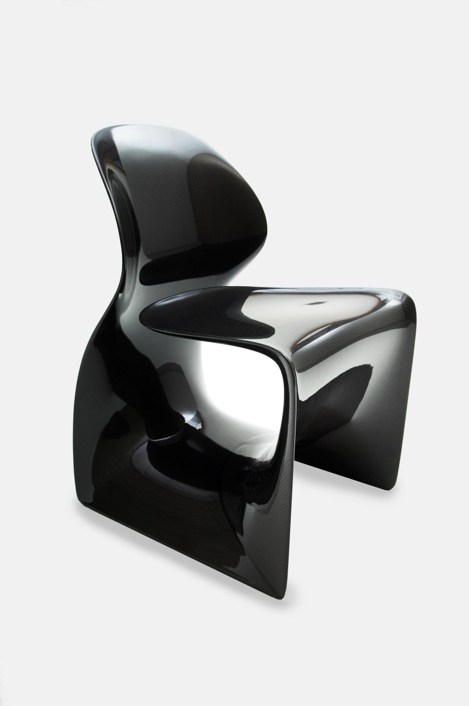 Sleek black contemporary chair designed by Established & Sons, showcasing innovative modern design and craftsmanship.