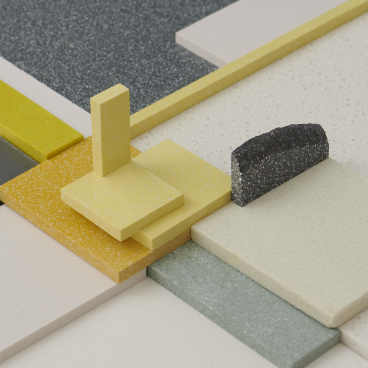 Colorful samples of Durat Plus surfaces made from recycled materials, showcasing innovative design and eco-friendly materials.