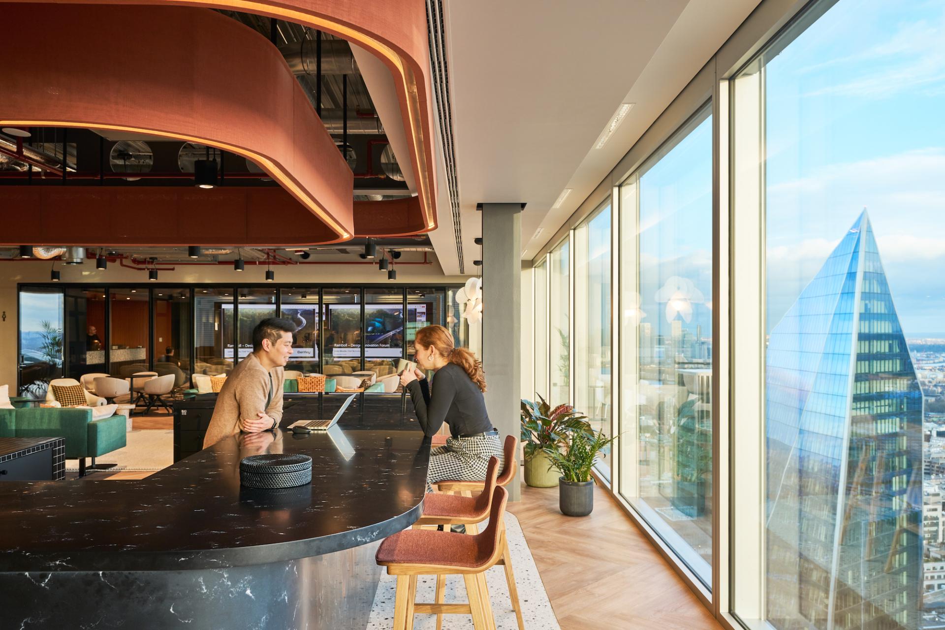 Contemporary workplace design featuring collaborative workspace, sleek furniture, and panoramic views at Bentley Systems headquarters.
