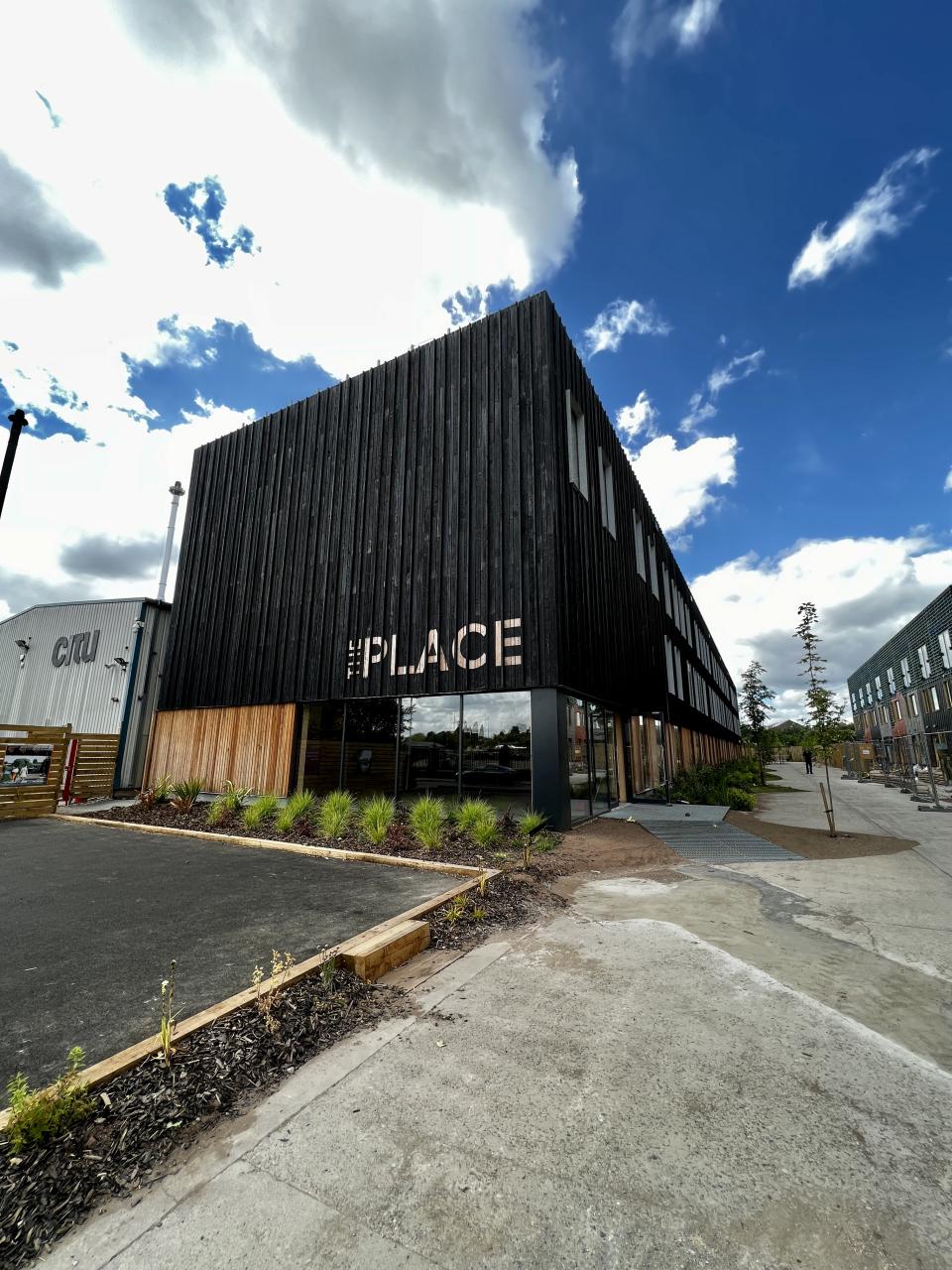 Modern net zero carbon workspace in Leeds, showcasing sustainable architecture with a wooden facade and landscaped surroundings.