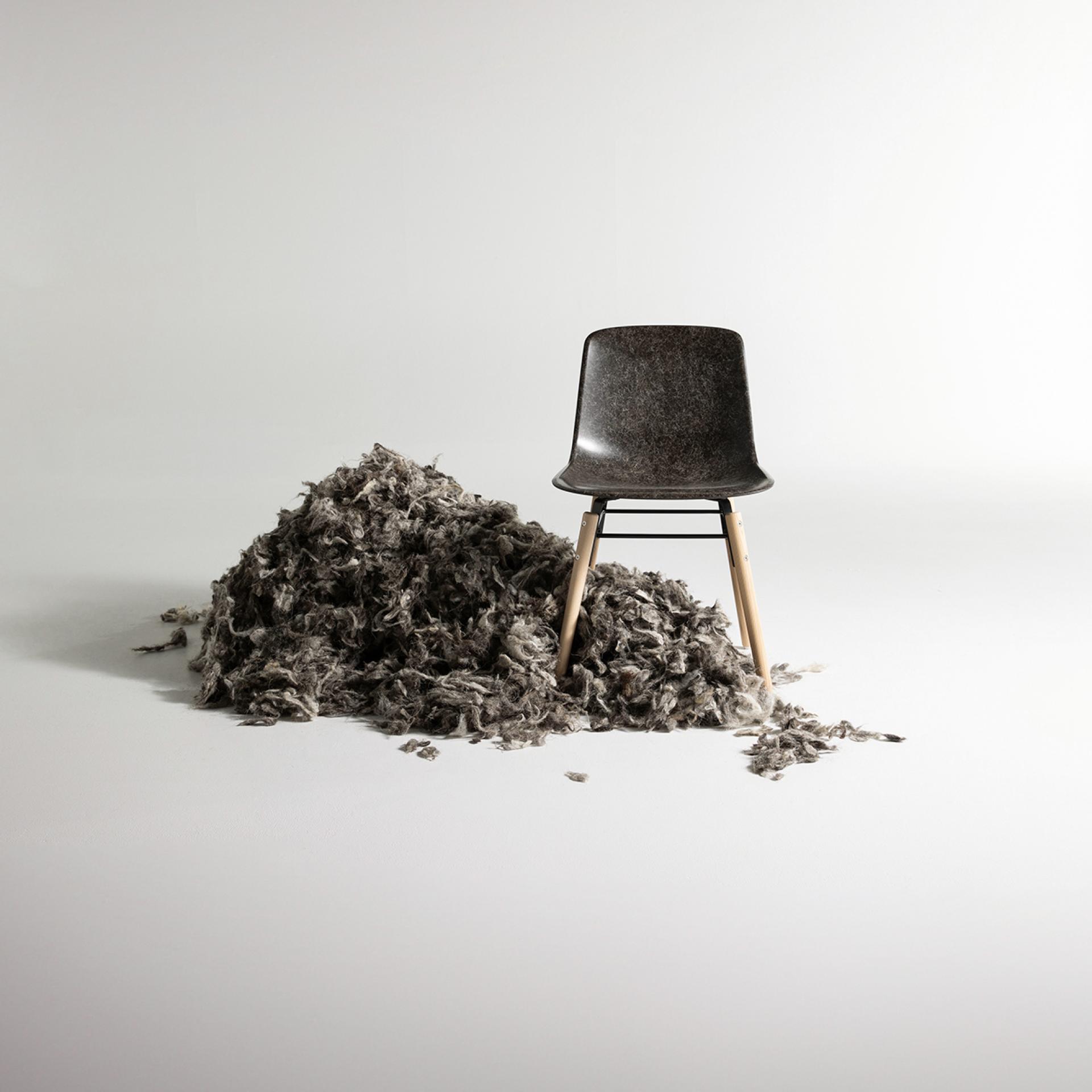 Sustainable furniture piece by Solidwool surrounded by wool by-products, showcasing eco-friendly design and artistry.