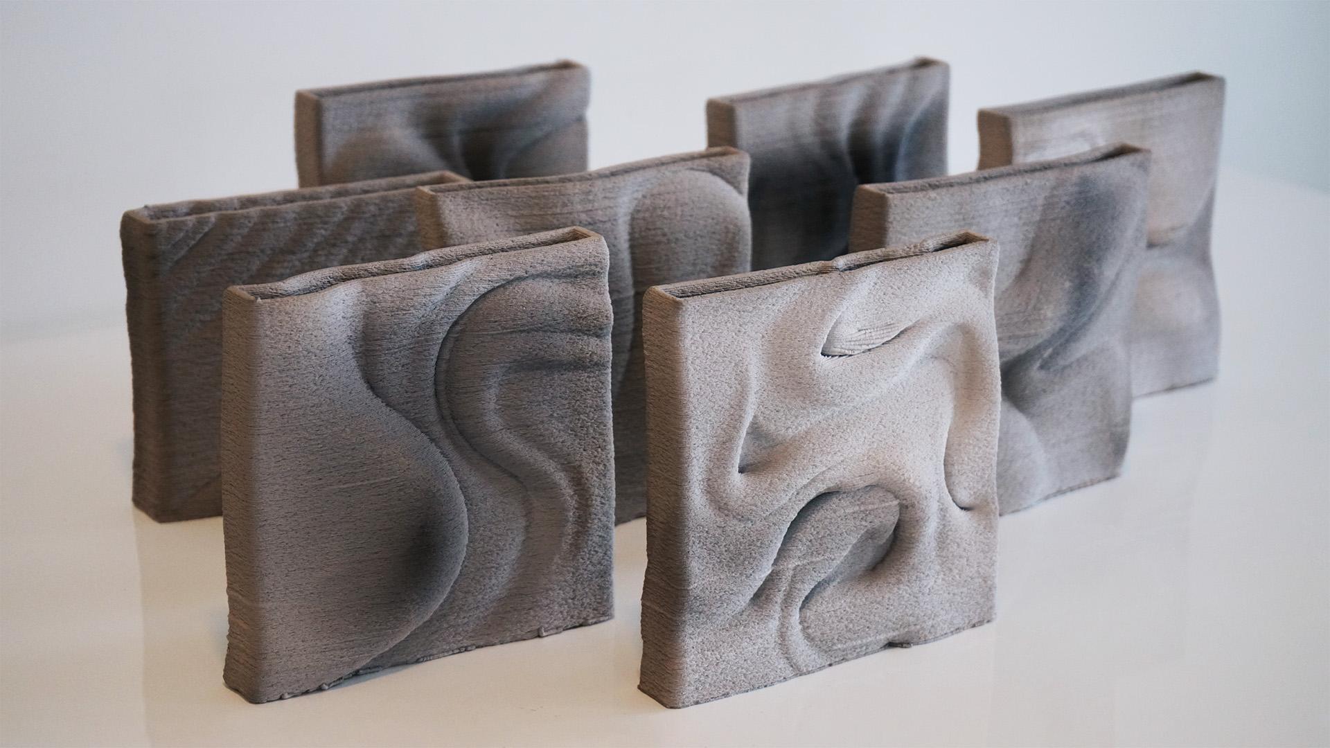 Textured biomaterial panels arranged artistically, showcasing innovative designs for low-carbon and waste-based products.